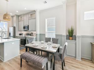 a kitchen and dining room with a table and chairs at Sandy Smiles in Galveston