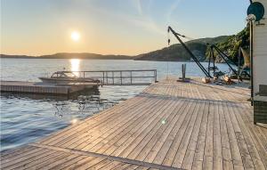a dock with a crane on top of a body of water at Stunning Home In Fitjar With Wifi in Fitjar