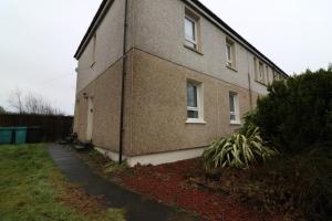 a brick building with a sidewalk next to it at Signature - Carrick View in Cumbernauld