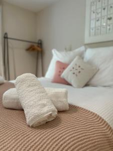 two towels sitting on top of a bed at Leafy lodge in Lytham in Brown Moss Side