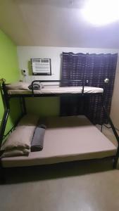 a bunk bed in a room with a laptop at Dion's Place in Iloilo City