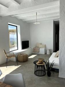 Sala de estar blanca con sofá y mesa en Casa Juncares, en Iznájar