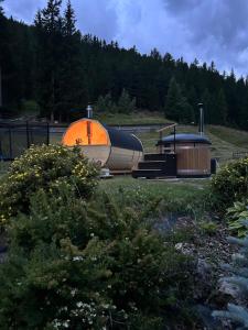 an orange and black boat sitting next to a building at Chalet Bucaneve in Santa Caterina Valfurva