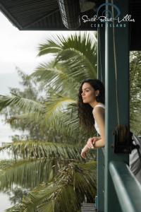 セール島にあるSouth Point Villas Cerf Islandの窓の外を見る長髪の女