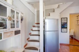 a kitchen with a staircase and a refrigerator at Ca' a riga in Diano Castello