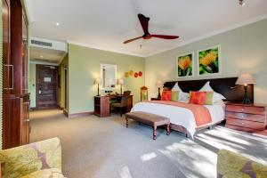 a bedroom with a large bed with a ceiling fan at Irene Country Lodge, Autograph Collection in Centurion