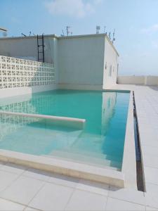 a swimming pool on the roof of a building at Medzam Homes Spacious Newly Furnished Studio in Mombasa