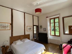 a bedroom with a white bed and a red light at Chambres d'Hôtes Les Tapies in Agen dʼAveyron +27 photos