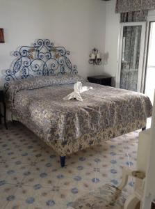 a bedroom with a bed with a metal frame at bb la guardiia in Anacapri