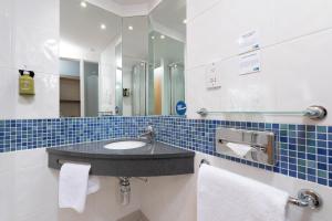 a bathroom with a sink and a mirror at Holiday Inn Express Ramsgate – Minster by IHG in Minster