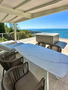 a large white table and chairs on a patio at Maximilian Suites in Trieste