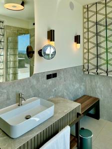 a bathroom with a sink and a mirror at Maximilian Suites in Trieste