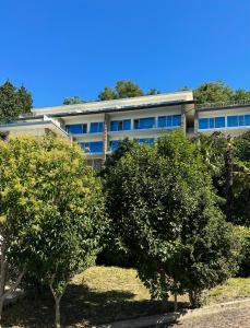 an office building with trees in front of it at Maximilian Suites in Trieste