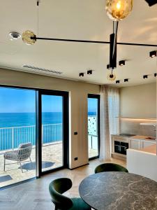 a dining room with a view of the ocean at Maximilian Suites in Trieste