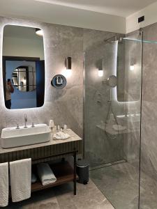 a bathroom with a sink and a shower at Maximilian Suites in Trieste