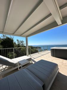 a bedroom with a bed and a view of the ocean at Maximilian Suites in Trieste