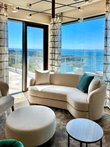 a living room with a couch and a large window at Maximilian Suites in Trieste