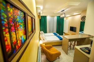 a room with a bedroom with a bed and a table at MD Apart Tbilisi in Tbilisi City