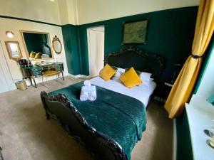 a bedroom with a bed with a teddy bear on it at Ashmount Country House in Haworth