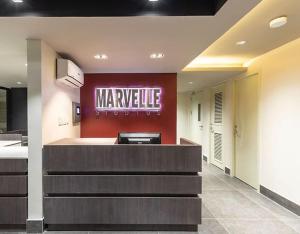 a lobby with a marmite sign on the wall at Marvelle Studios in Manila