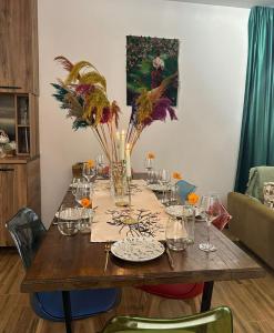 a wooden table with glasses and vases on it at WoodStar/ტყის ვარსკვლავი in Ambrolauri