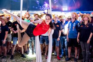 a woman is on a pole in front of a crowd at RacingTours RaceCamp - Spielberg in Spielberg