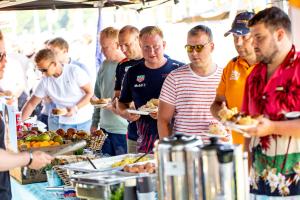 a group of people standing around a buffet of food at RacingTours RaceCamp - Spielberg in Spielberg