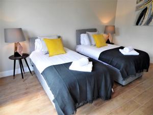 A bed or beds in a room at Signature - Langlands House