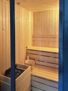 a sauna with wood paneling and a chair in it at Roiss Haus Suites in Lecce