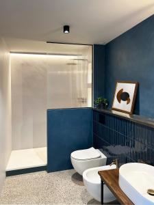 a bathroom with a toilet and a sink and a shower at Roiss Haus Suites in Lecce +134 photos