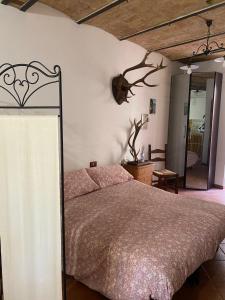 a bedroom with a large bed and a mirror at Mini House Tagliacozzo in Tagliacozzo