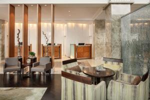 a lobby with chairs and a table and a podium at Sheraton Bratislava Hotel in Bratislava