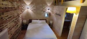 Кровать или кровати в номере Duplex de L'Artisterie