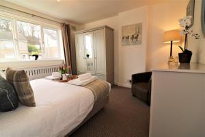 a hotel room with a bed and a window at Signature - Gordon House in Glasgow