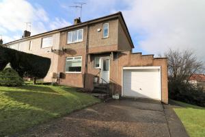 a brick house with a white garage at Signature - Gordon House in Glasgow