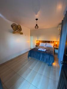 a bedroom with a bed with blue sheets and lights at Suites da Rota - Pomerode SC in Pomerode
