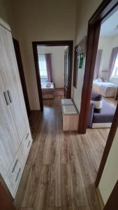 a room with wooden floors and a room with two beds at Hotel Mikorzyn in Ślesin