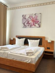 a bedroom with a large bed with white sheets at Hotel Adam in Berlin +28 photos