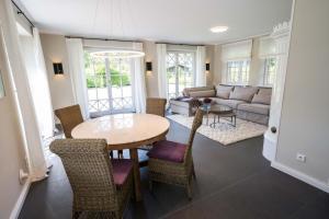 a living room with a table and chairs and a couch at Smuk Huus in Nieblum