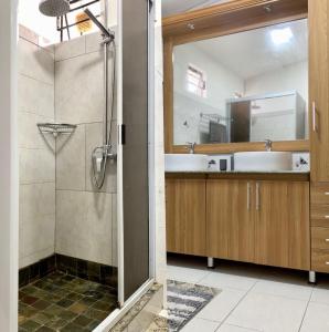 a bathroom with a shower and a sink at White Castle villa in Pereybere