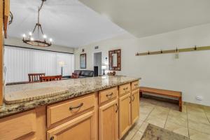 a kitchen with a counter top and a living room at Edelweiss Haus in Park City