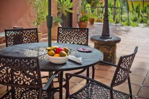 a table with a bowl of fruit on a patio at Tamahuche Hotel Rural in Vallehermoso