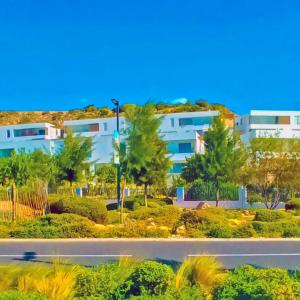 an apartment building with a road in front of it at Golf View, bord de mer, Pool, Surf,T3 Nakta à Taghazout in Taghazout