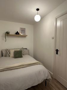 a bedroom with a large bed with a light on it at Cosy 1BD Getaway Perfect for Couples Stamford in Stamford