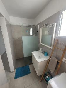 a bathroom with a sink and a shower with a mirror at Las Princesas in El Médano