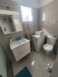 a bathroom with a sink and a toilet and a mirror at Las Princesas in El Médano