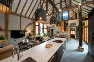 a kitchen and living room in a wooden house at Cloth Worker's Barn in Smarden