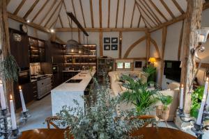 a large kitchen with a center island in a room at Cloth Worker's Barn in Smarden