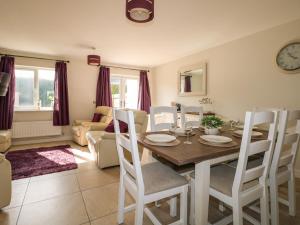 a kitchen and dining room with a table and chairs at Pebble House in Worthing