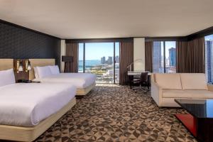 a hotel room with two beds and a desk at Hilton Miami Downtown in Miami